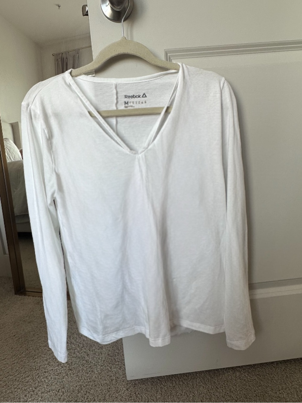Reebok Women’s White Long-Sleeve Strappy V-Neck Pullover with a Tied Back